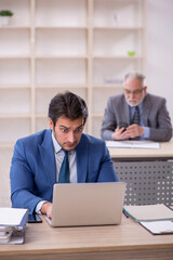 Two male colleagues working in the office