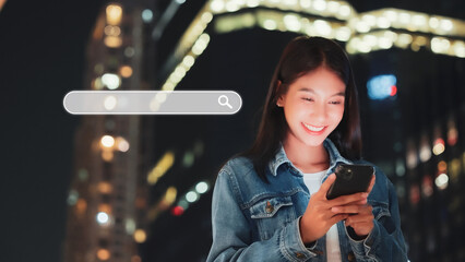 Asian women using smartphones to find what they are interested in city night life. Searching...