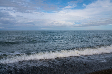 Black Sea on the Sochi coast and a pebble beach on a sunny day with clouds, Sochi, Krasnodar Territory, Russia