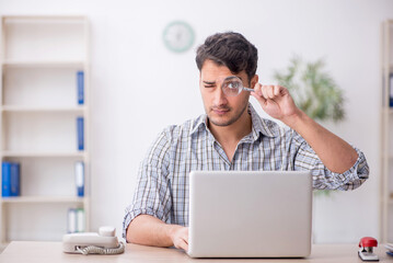 Young male employee working in the office