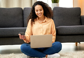 You dont just work to pay bills, spoil yourself. Shot of a woman holding a credit card while using her laptop.