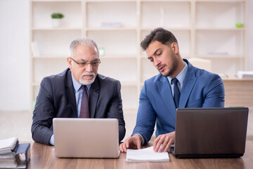 Two male employees working in the office