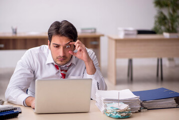 Young male employee working in the office