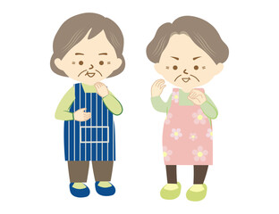 エプロンをつけたシニアの女性二人が笑顔で会話をする様子②