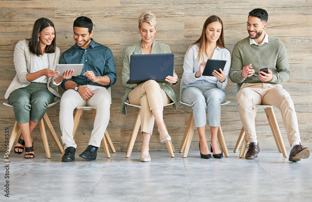 Poster Business could not exist without technology. Full length shot of a diverse group of businesspeople sitting in a row together and using technology.