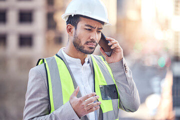 Changes Now. Cropped shot of a handsome male construction worker making a call while standing on a building site.