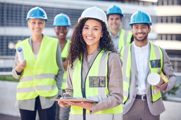 On site, on demand. Cropped shot of an attractive female construction worker standing outside on a building site with her colleagues.
