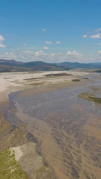 A shallow river in the dry season in a mountain valley. Bucao river. Luzon, Philippines. Vertical video.
