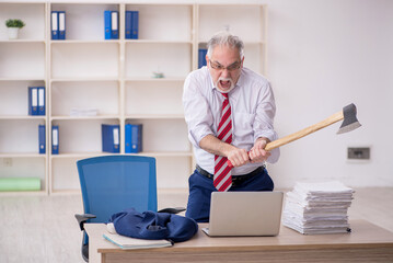 Old male employee unhappy with excessive work in the office