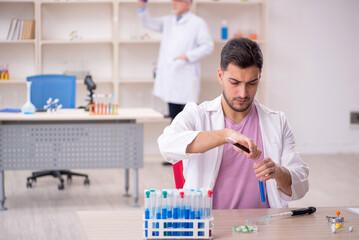 Two male chemists working at the lab