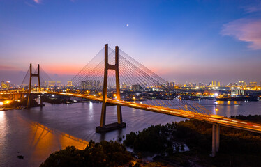 Fototapeta na wymiar Sunset at Phu My bridge, Saigon riverside, Ho Chi Minh city, Vietnam. April 2023