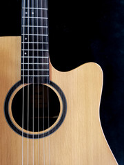 close up shot of guitar sound hole , with cedar wood top.