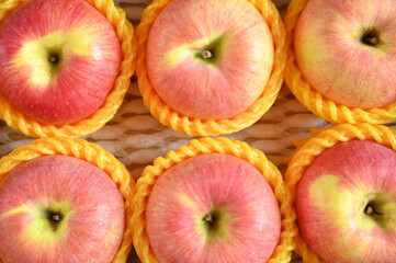beautiful pink apple in yellow wrap bubble, healthy fruit in the box