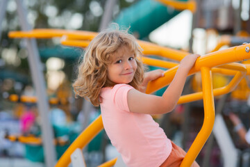 Little boy playing on the playground. The emotion of happiness, fun, joy. Smile of a child.