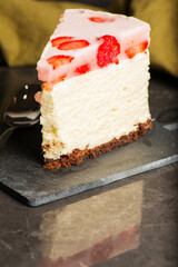 Homemade mixed berry cheesecake with a biscuit crumb and fruit puree.