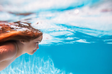 Beach sea and water fun. Kid swimming in pool underwater. Child boy swim under water in sea.
