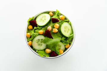 Green vegan salad from green leaves mix and vegetables. Top view on white background.