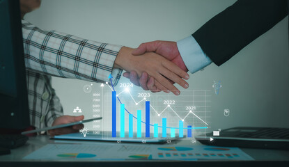 Man and woman are shaking hands in office. Data Management System to make report with KPI. Corporate strategy for finance marketing analysis joint business agreements in the future.