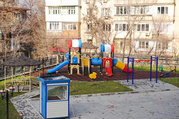Fototapeta na wymiar Almaty, Kazakhstan - 11.23.2015 : Children's playground on the territory of a multi-storey residential complex.