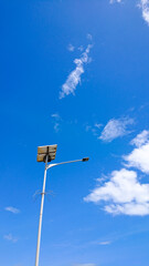 a street lamp pole that uses solar power with a clear sky