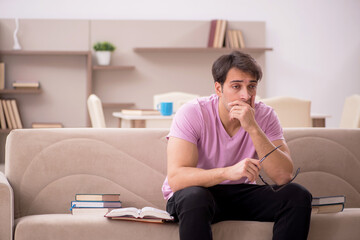 Young male student preparing for exams at home