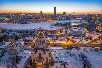 Fototapeta na wymiar Winter Yekaterinburg and Temple on Blood in beautiful blue clear sunset. Aerial view of Yekaterinburg, Russia. Translation of the text on the temple: Honest to the Lord is the death of His saints.