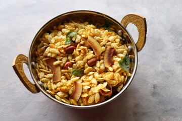 Jada Poha Namkeen Chivda or Thick Pohe Chiwda. Diwali special savory snack, made out of puffed rice, fried peanuts, curry leaves and some spices. Traditional Indian Diwali Snacks. with Copy Space.