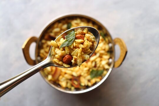 Jada Poha Namkeen Chivda or Thick Pohe Chiwda. Diwali special savory snack, made out of puffed rice, fried peanuts, curry leaves and some spices. Traditional Indian Diwali Snacks. with Copy Space.