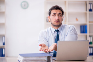 Young male employee working in the office