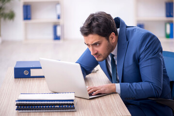 Young male employee working in the office