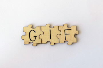 The acronym GIF, which stands for Graphics Interchange Format. The letters written on the puzzles.
