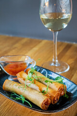 spring rolls with wine in cafe