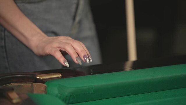 Russian billiards. girl tapping her fingers on the edge of the billiard table.close-up of her hand.slow motion video.High quality Full HD video footage