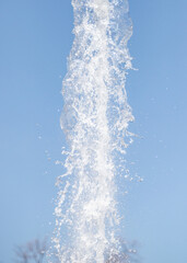 Obraz na płótnie Canvas splashing water from a fountain against the blue sky