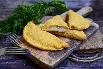 
 Crispy  deep fried home made    Cordon bleu with cheese   and ham   on wooden rustic background.  