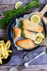   Allasca Pollock Fish  Bites in a crispy Tempura  Batter.Fish and chips .Close up of   crispy breaded  deep fried fish fingers with breadcrumbs s erved with remoulade sauce and  lemon