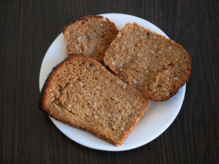 whole grain bread in plate on wooden background, Organic Homemade Whole Wheat Bread, closeup