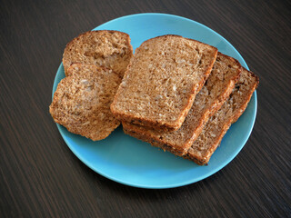 whole grain bread in plate on wooden background, Organic Homemade Whole Wheat Bread, closeup