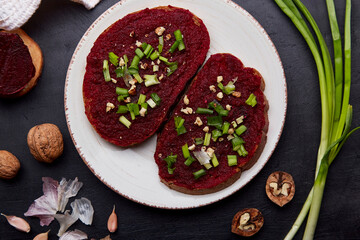 Beetroot spread with spring young onion and walnuts sandwiches. Healthy vegan food. Top view.