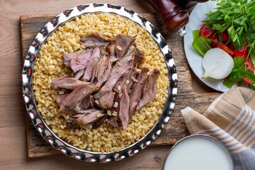 Turkish foods; lamb shank tandoori on bulgur wheat rice (Turkish name; bulgur bugday pilavi kuzu incik tandir)