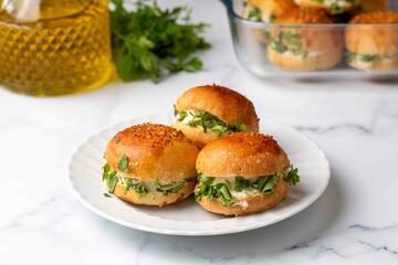 Turkish pastry filled with dill, parsley, cream cheese and cheddar cheese. Turkish name: Sakallı Pogaca or Saçaklı Pogaca