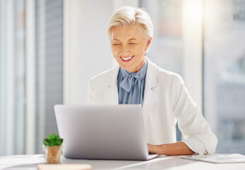 Laptop, smile and senior business woman in office excited for research, idea and mission plan. Online, project and happy elderly female manager cheerful while typing, browsing and planning proposal