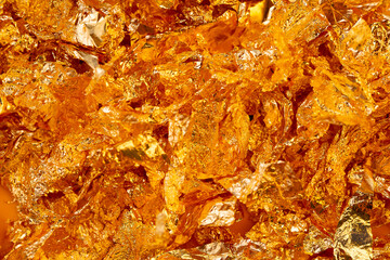 Golden texture background. Golden potal close-up glitters and shimmers. Golden holiday background.
