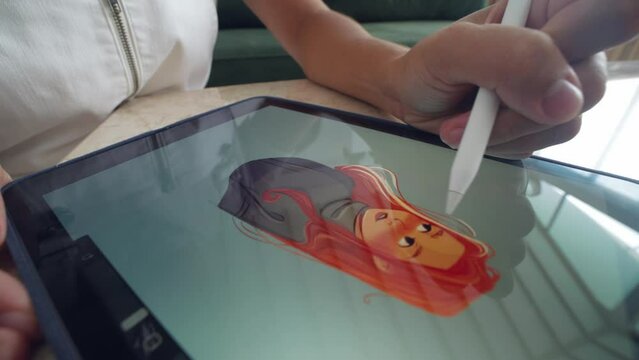 Digital artist draw pc tablet close up. Designer paint red head girl pic. Illustrator use ipad stylus pen. Pad user develop art skill. Person make work app. Hand hold color pencil. Woman game logotype