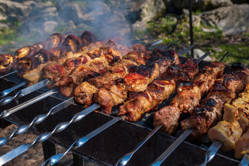 Cooking meat on a skewers. Bbq or barbecue meat. Picnic outdoor. High quality photo.
