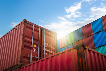 Fototapeta premium Stacked Containers Cargo Shipping with A Blue Sky. Handling of Logistic Transportation Industry. Cargo Container ships, Freight Trucks Import-Export. Distribution Warehouse Logistics Transport