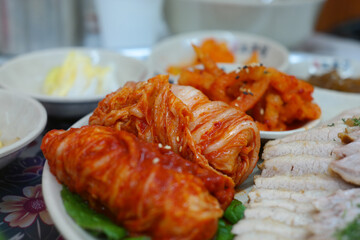 Korean traditional food with thinly sliced boiled pork and freshly made cabbage kimchi