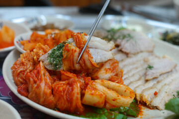 Korean traditional food with thinly sliced boiled pork and freshly made cabbage kimchi