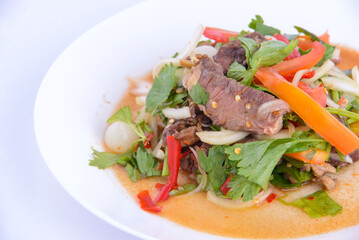 Favorite food of Thailand. Spicy grilled pork salad on the white background.
