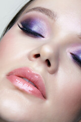 Woman with lilac beauty eyes makeup. Female with purple smoky eyes eye shadows.